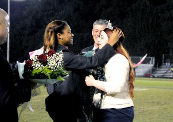 Nicole Perri was crowned Morgan City High School’s 2013 homecoming queen during Friday’s football game against Ellender. From left are Principal Mickey Fabre; 2012 queen Ariel Trimm; Perri’s father, Tim Spiese; and Perri.