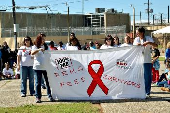 Women from Claire House, a drug and alcohol treatment center in Bayou Vista, display their banner Saturday during the banner competition.