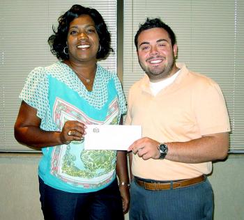 The City of Patterson received a donation from Patterson State Bank to be used in purchasing necessary items to host a Business After Hours event at City Hall held Oct. 17. Sandra Turner, left, head customer service representative for Patterson State Bank, provides Ryan Aucoin of the City of Patterson with a check for the donation.
