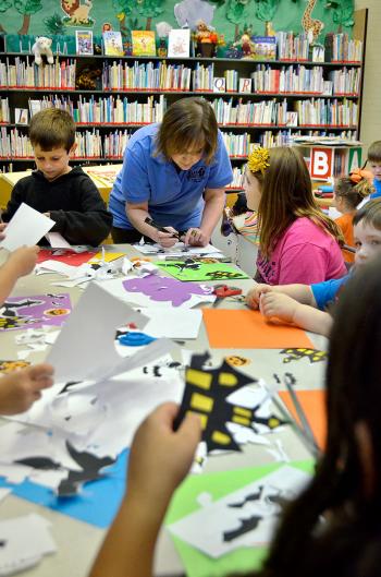 Gathering to cut out and color “Halloween Silhouette’s” were, left photo from left, Daniel Vasquez, library clerk Trish Dupre, Peyton Skiles, Eli Dupuis, and Katie Walicky. 