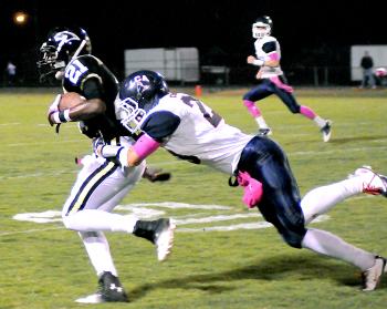 Berwick’s Audin Williams fights for yardage while a Lafayette Christian defender brings him down during the teams’ matchup Friday in Berwick. Lafayette Christian rallied for a 28-24 victory.
