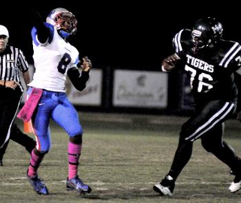Morgan City’s Daryl Johnson, right, pressures Ellender quarterback Curtis Anderson during the squads’ District 7-4A contest in Morgan City last Friday. Morgan City will travel to face South Terrebonne Friday in district action in Bourg.
