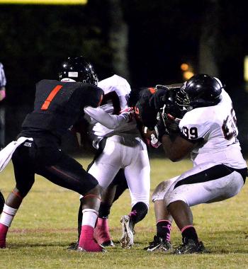 Patterson’s Kendall Hunter, left, and Earl Johnson converge on a Donaldsonville ballcarrier during the squads’ district  contest Friday. Patterson’s defense limited the Tigers to just 125 yards of total offense in the Lumberjacks’ 50-7 drubbing.