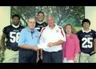 M C Bank made a donation to Patterson High School for their football scoreboard upgrade. Accepting the donation from M C Bank Executive Vice President Gerald Listi are Tommy Minton, Patterson head football coach and athletics director, and senior football players. From left are Kevin Merritt, Listi, Landon Thomas, Minton, Frances Dupre, M C Bank Human Resources/Marketing Officer; and Rene Maillet.